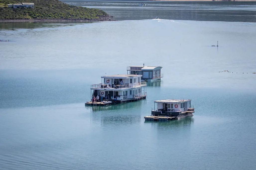 Houseboats floating in the peaceful lake.